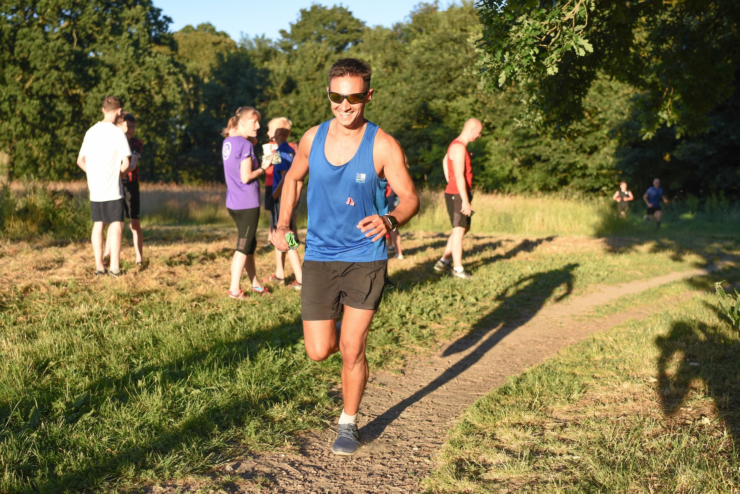 man running through park on hot day