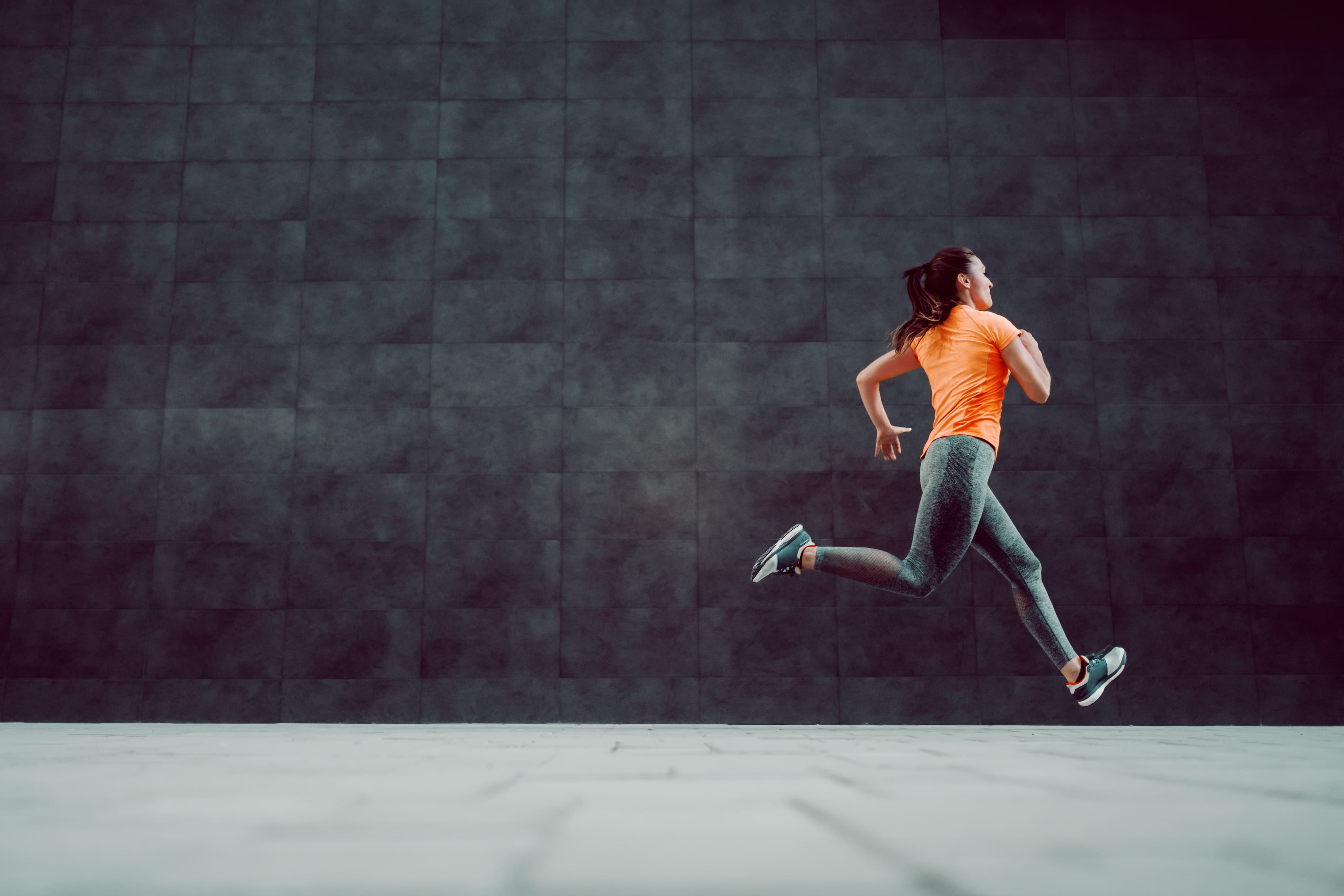 lady in orange top running